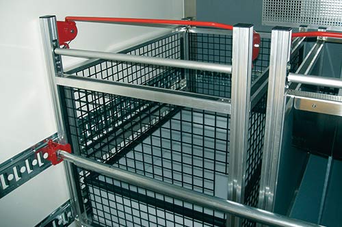 Roll container holder securing a whole row of roll containers